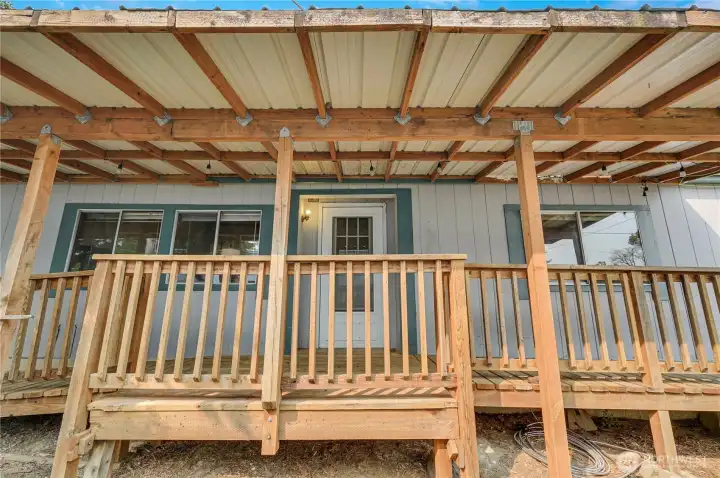 Unattached deck & roof to front door.