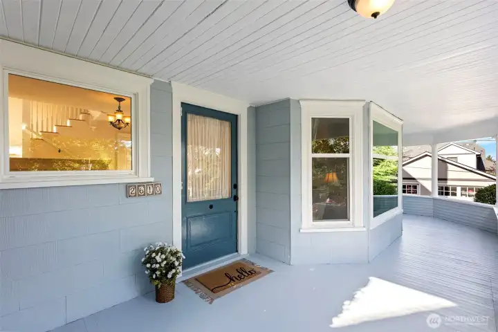 Freshly painted storybook wrap around front porch with the original doorbell you have to try! There's plenty of room to relax with a good book or your morning cup of coffee.