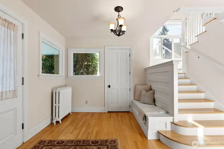 Natural light pours through every window, highlighting updated windows and oak hardwood floors.