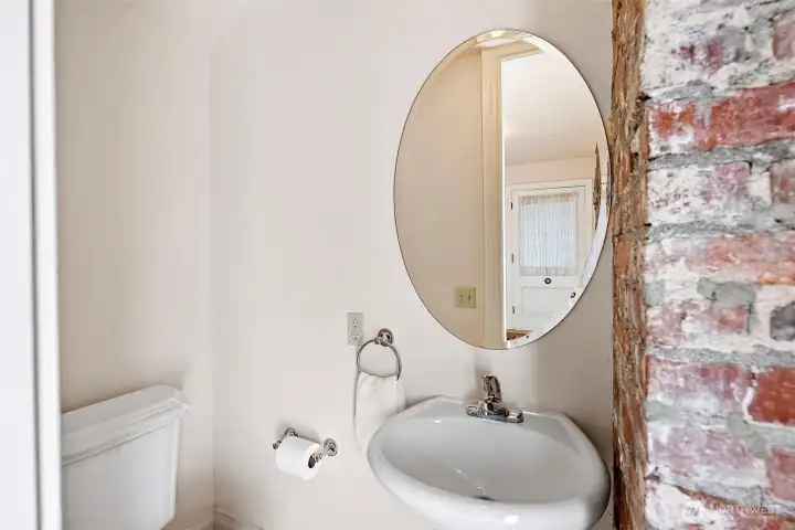 Convenient powder room located off the entry way and at the base of the stairs.