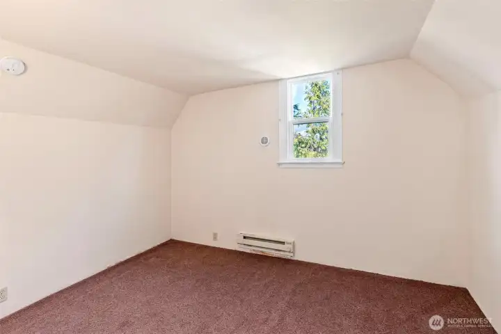 Small upstairs bedroom with a peek-a-boo view.