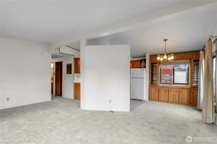 A view from the living room toward hall, kitchen, and dining room.