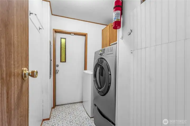 A convenient laundry room off the hall with access to the back door. Washer and dryer stay.