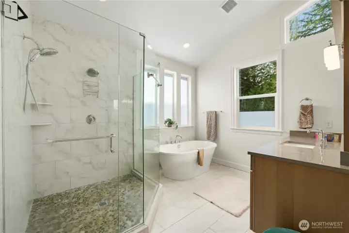 Large spa-like primary bathroom with upgraded finishes.
