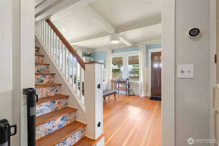 From kitchen into formal dining room on left and living room on right. Stairs to primary suite.