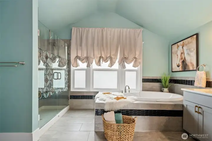 Custom ensuite with walk in shower, soaking tub and slate floors