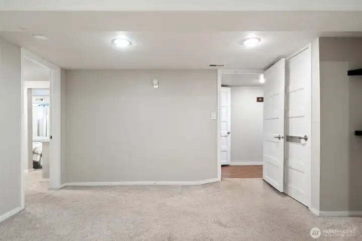 Lower level rec room with 2 bedrooms through the doors