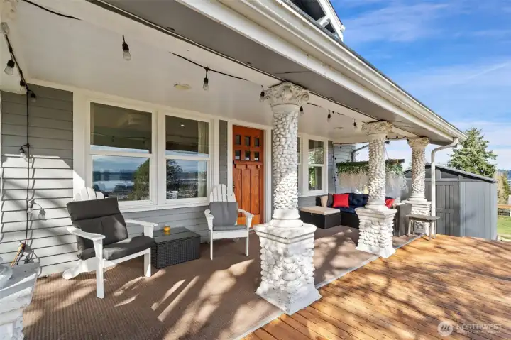 Covered porch with deck. Amazing pillar columns are original.