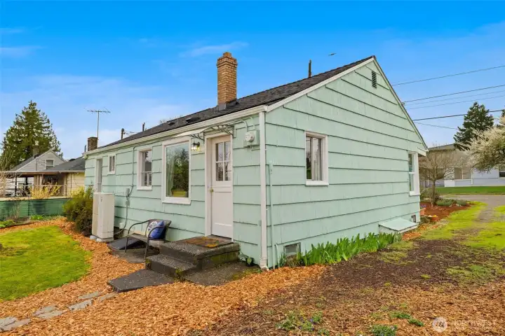 Back view of the home.  Notice the heat pump system for high efficiency heating and cooling.