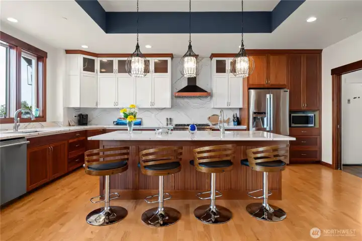 Custom Cambria quartz countertops and  mahogany cabinetry delight in this kitchen.