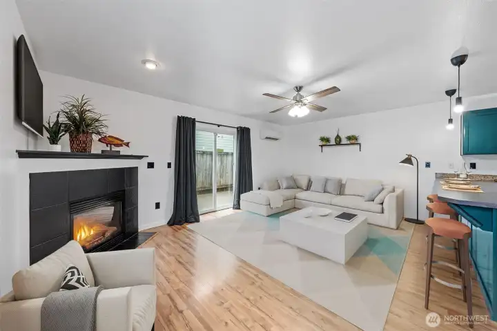 Enjoy the main living area for lively conversations, movie nights or family/friends gatherings. With a flick of a switch, you'll have a fireplace keeping you warm on chilly nights while a mini-split keeps you cool in summer. A slider leads out to a compact patio.