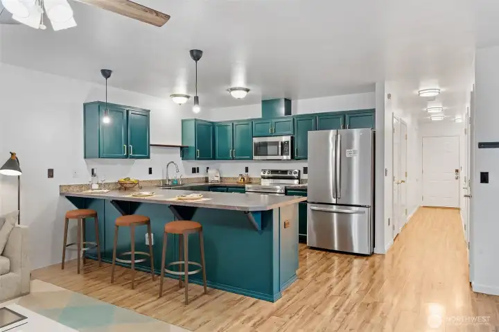 Well-designed kitchen includes all stainless steel appliances...including GE smooth cooktop/oven and French door fridge/freezers as well as a Bosch dishwasher. A half-bath is just a few steps away.