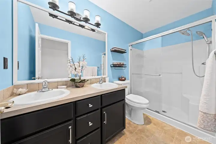 Dual sinks and a custom shower provides two shower head options for relaxation.