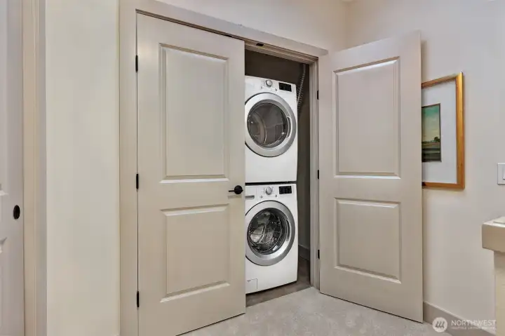 At the top of the newly carpeted stairs is a full size washer and dryer plus extra closet space to hang clothes.
