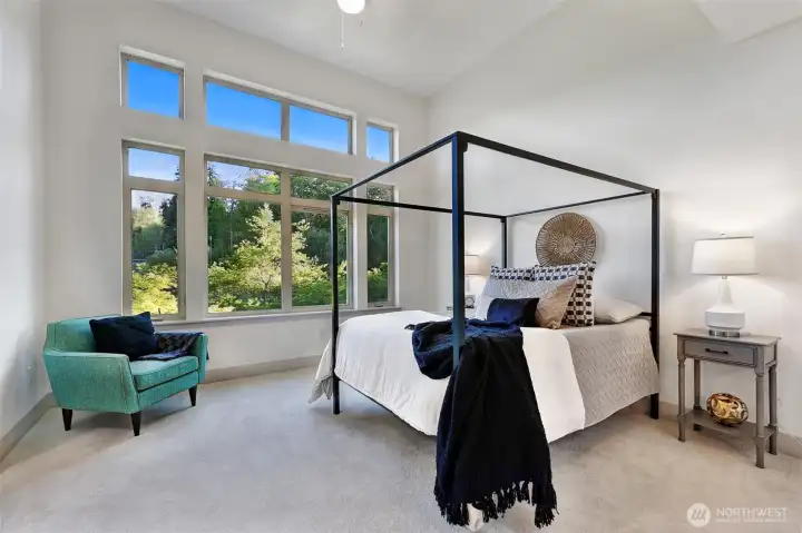 The primary suite can accommodate a king size bed.  The ceiling is 14 feet high and the new carpet continues in the bedroom.
