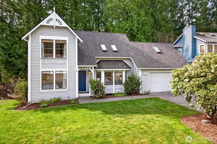 Classic two-story styling with decorative gable trim, shingle accents, and a signature blue door anchors a memorable presence in one of Redmond's most coveted Northshore School District enclaves.
