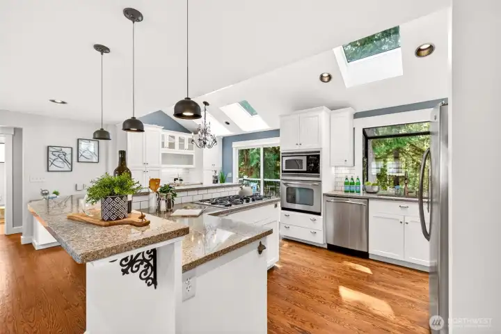 The expansive island with gas cooktop and bar seating connects effortlessly to the great room and dining nook, keeping the cook at the center of every conversation.