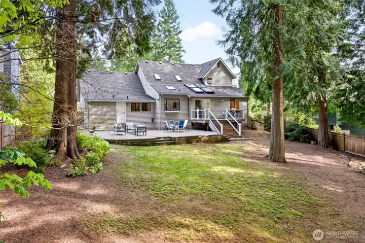 The 10,958 sq. ft. lot opens to a parklike backyard surrounded by towering Pacific Northwest evergreens, offering rare privacy and room to enjoy the outdoors year-round.