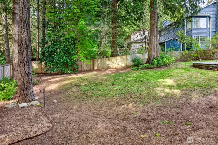 A fully fenced backyard backing to mature trees delivers the privacy, space, and quiet seclusion that's increasingly rare on the Eastside.