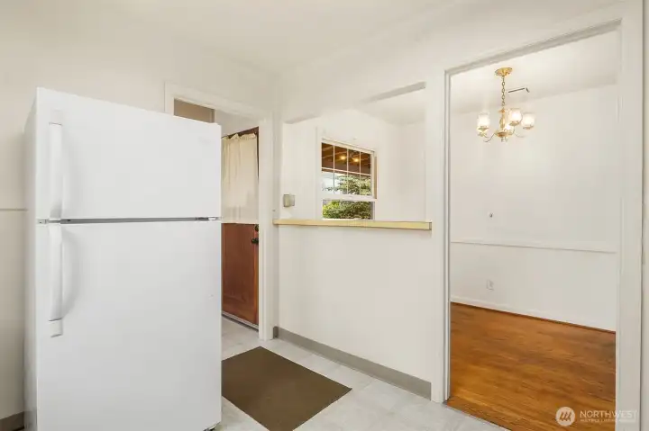 Kitchen with seamless flow into laundry & dining.