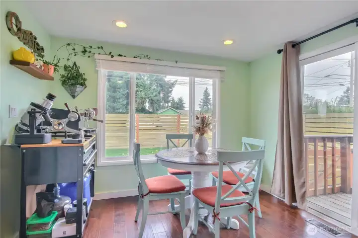 Sun-drenched dining area with sliding door to outside oasis. Sun-drenched dining area with sliding door to outside oasis.