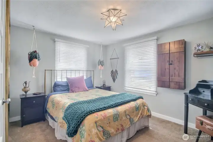 Primary bedroom with corner windows. Primary bedroom with corner windows.