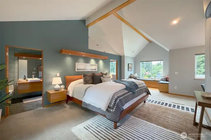 Huge first primary enjoys wood beamed vaulted ceilings, built night tables, sweet nook for just looking out to your garden and another desk for to complete this space., Huge first primary enjoys wood beamed vaulted ceilings, built night tables, sweet nook for just looking out to your garden and another desk for to complete this space.,