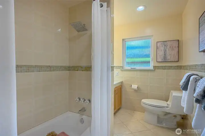 Main bath off hall with new tile and counters. Main bath off hall with new tile and counters.