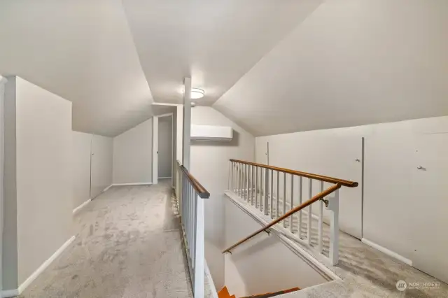Let's explore the upper level. Newer carpeting runs throughout with an HP min-split for year-round comfort. Access to the attic storage area is to the right.
