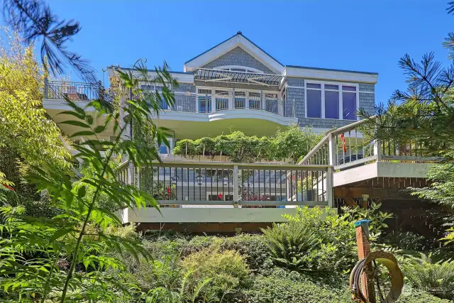 Custom-built Lake Washington view home surrounded by spectacular mature gardens with blue theme threaded throughout.