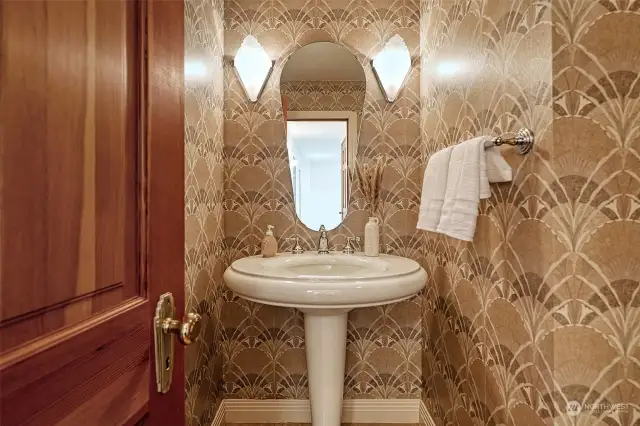 Upper Level Guest Powder Room with stunning pedestal sink & wall sconces flanking the vanity mirror; Designer wallpaper.