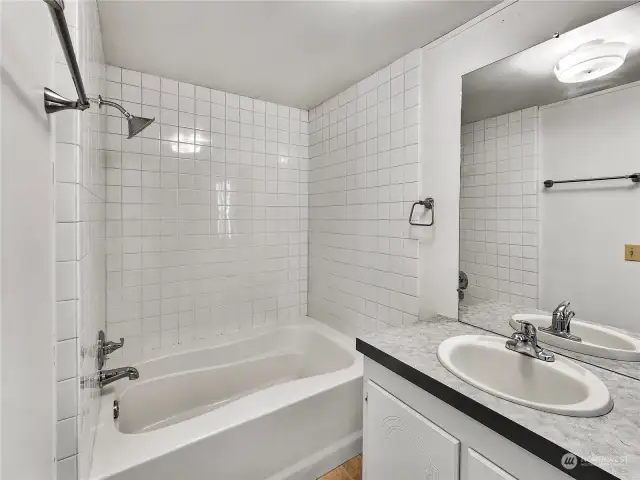 A light and bright primary bathroom designed for both comfort and convenience. This space features ample natural light, fresh updates, and a large storage closet perfect for keeping essentials organized