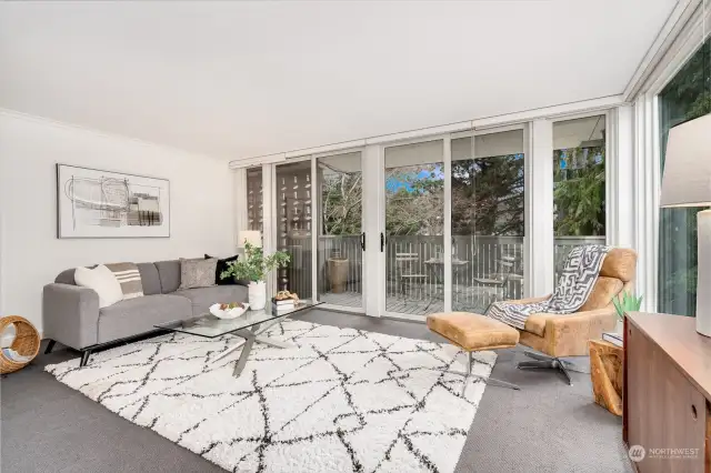 Large, light-filled living room with floor to ceiling windows in this private, corner unit.