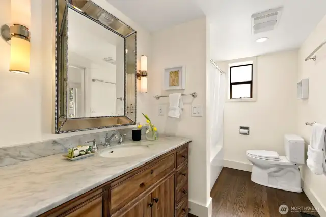 Primary bath with Restoration Hardware vanity, beveled beaded mirror and fixtures/towel bars.  Carrera marble counters and additional bath closet.
