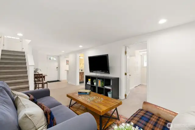Lower-level carpeted family room with two additional bedrooms and another finished room with closet.