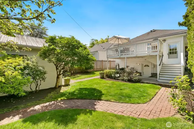Secret garden feel of back yard.  Street-to-street lot.  Seller has plans/bids for a new garage with living quarters above.