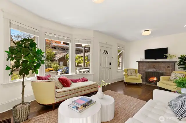 Living Room enjoys bay window, art space galore and espresso-stained hardwood floors throughout main floor.