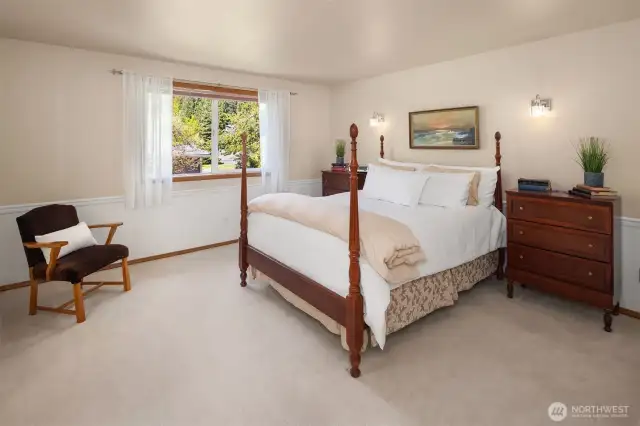 Primary bedroom with wainscotting detail.  Large walk-in closet is to the left of this photo.