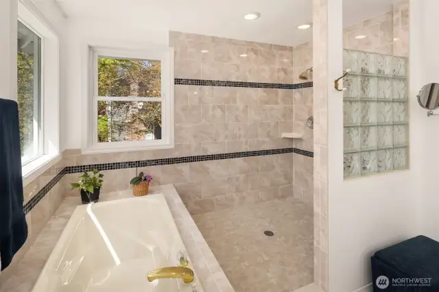 Massive tiled shower and soaking tub look out over your private backyard.