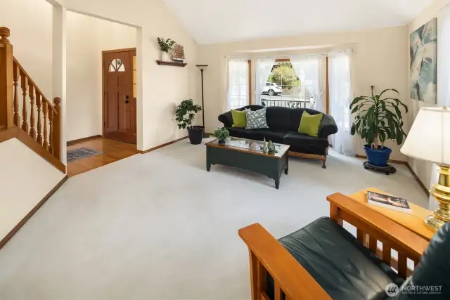 Oak hardwood floors, vaulted ceilings and bay window greet guests.