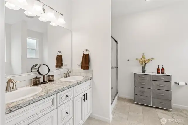 Pretty primary bath offers two sinks, separate shower and soaking tub