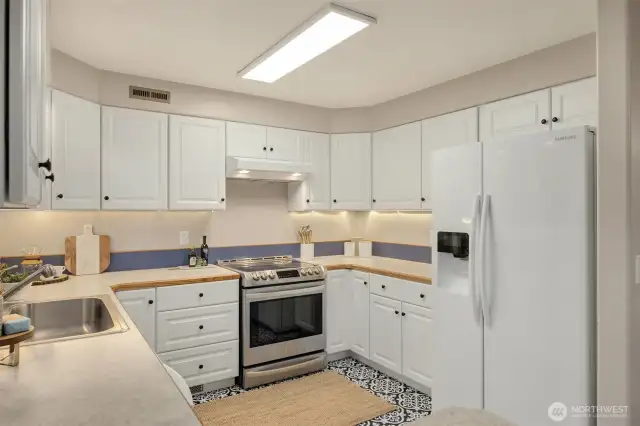 Bright and light kitchen with white cabinetry.