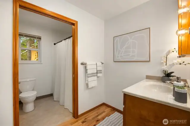Primary bath features separate sink and toilet/shower areas.