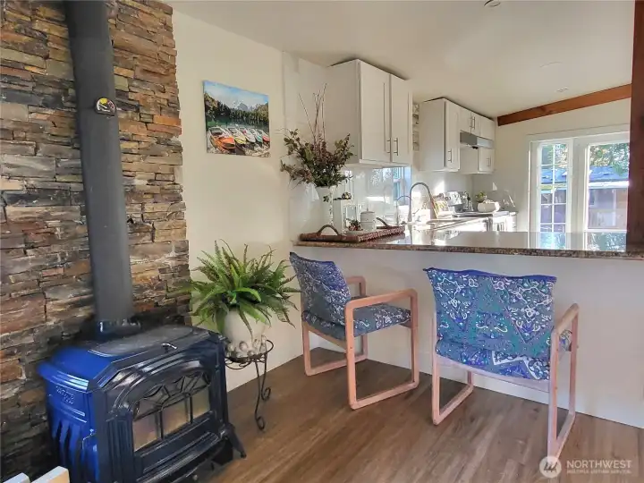 wood burning fireplace beside breakfast nook.