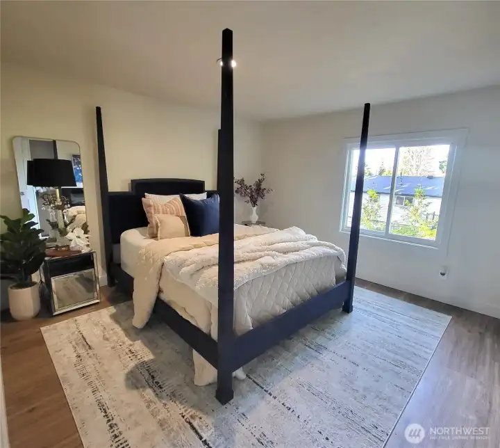 main bedroom with electric fireplace and 2 closets.