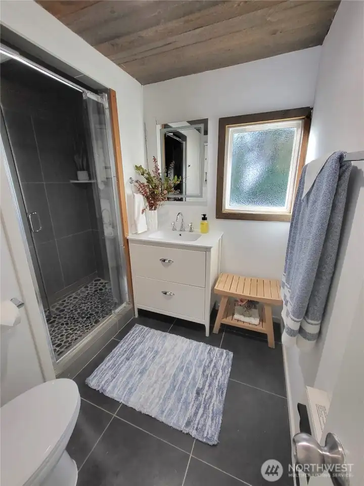 tiled bathroom with updated vanity and sink