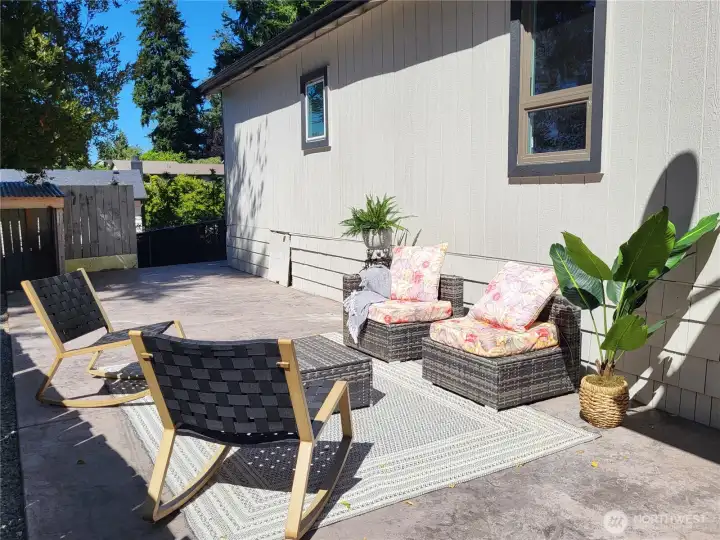Secluded side patio area beside a green belt.
