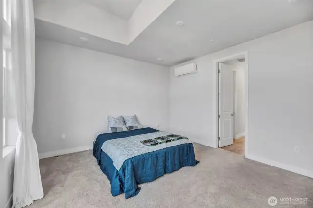 Primary bedroom showing entry to walk in closet and bathroom