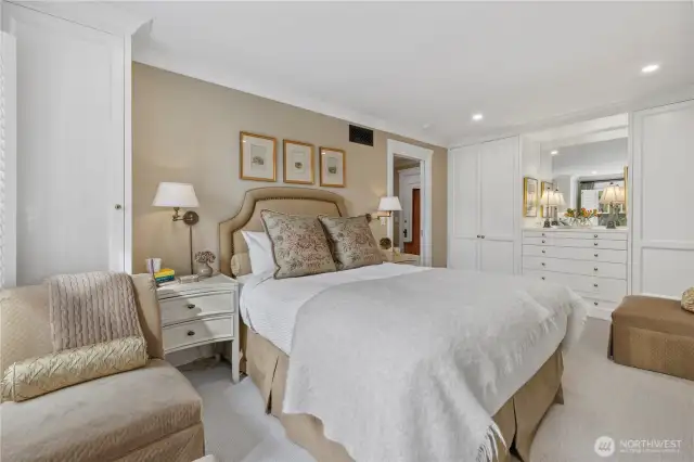 to the left of bed is more custom storage and along the back wall you can see a full length build out with more wardrobe storage and vanity area
