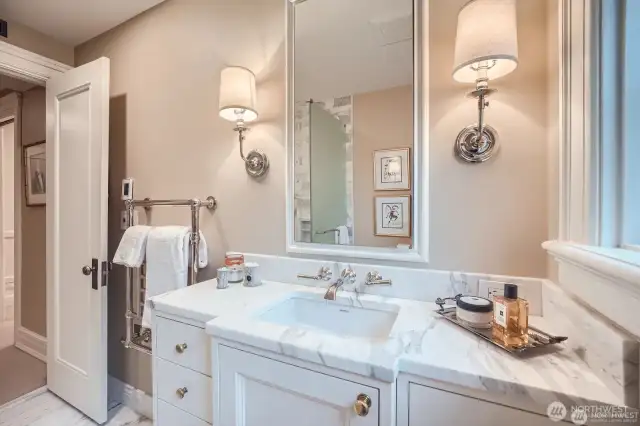 heated towel, calcutta marble floors- and counter, rich hardware and solid wood vanity.  Enjoy views as well from the bath, with window off the right of the vanity